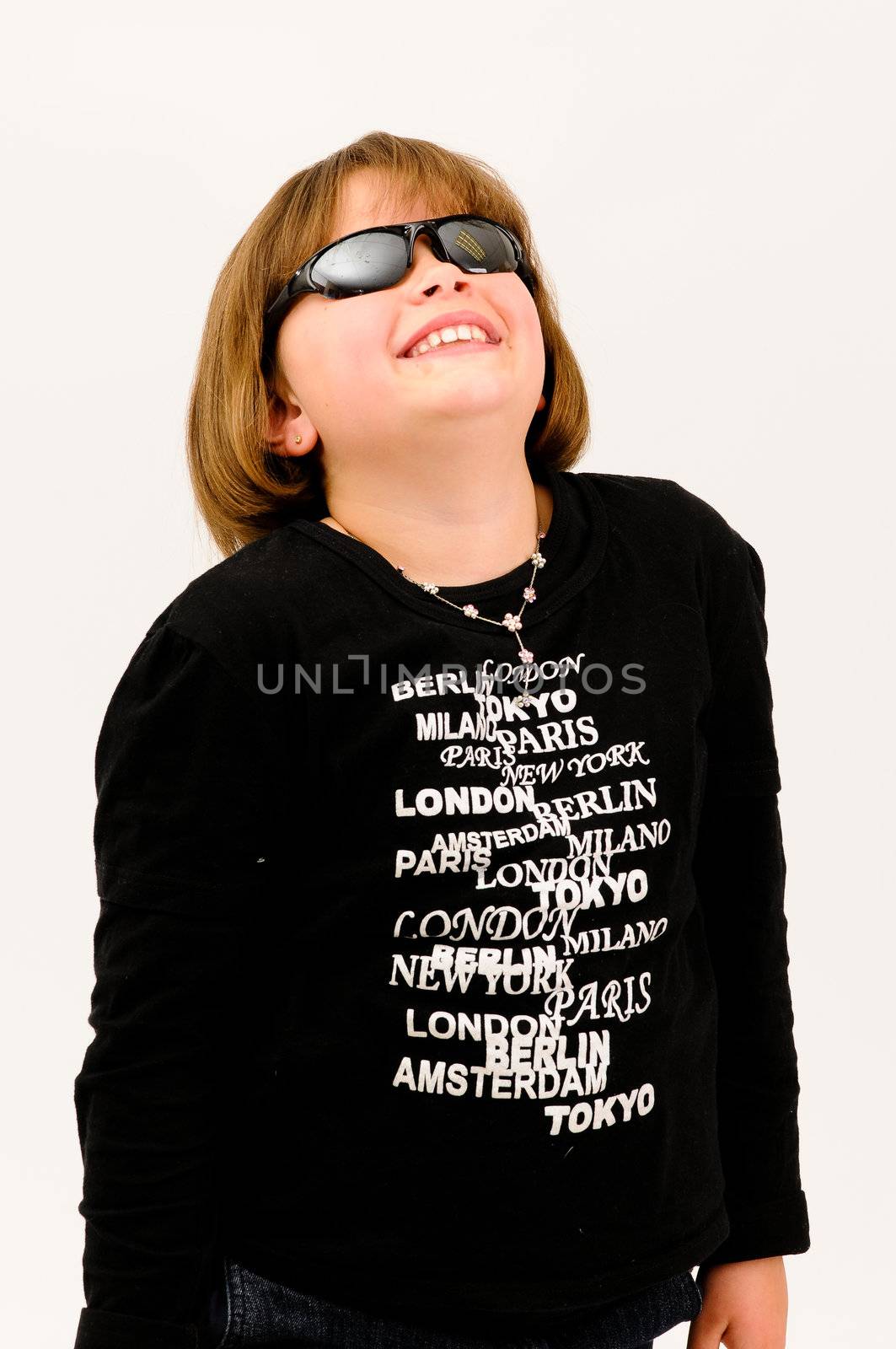 young beautiful  teenager with sun glasses smiling with dimple in cheek looking up by Ansunette