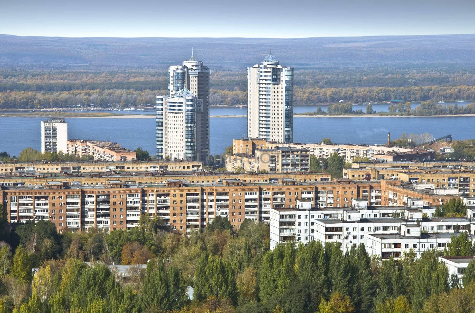 Urban landscape. Typical residential area on the riverbank. The view from the heights in the background high-rise apartment building. Russia.  