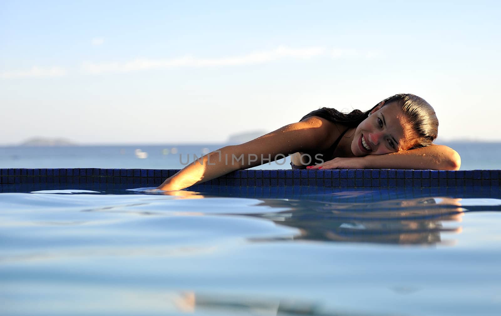 Pretty woman enjoying the swimming pool in Buzios, Brazil