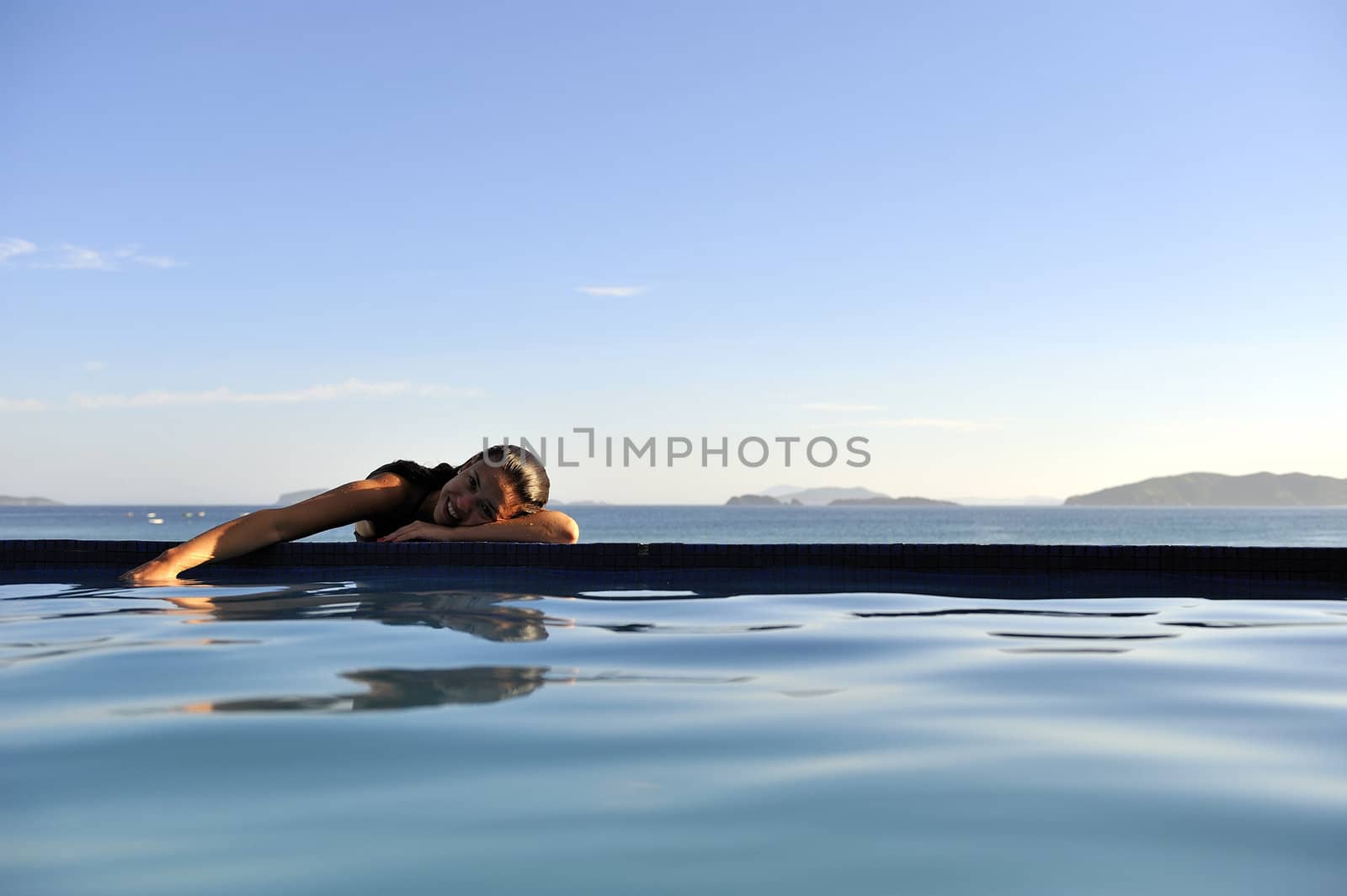 Pretty woman enjoying the swimming pool in Buzios, Brazil