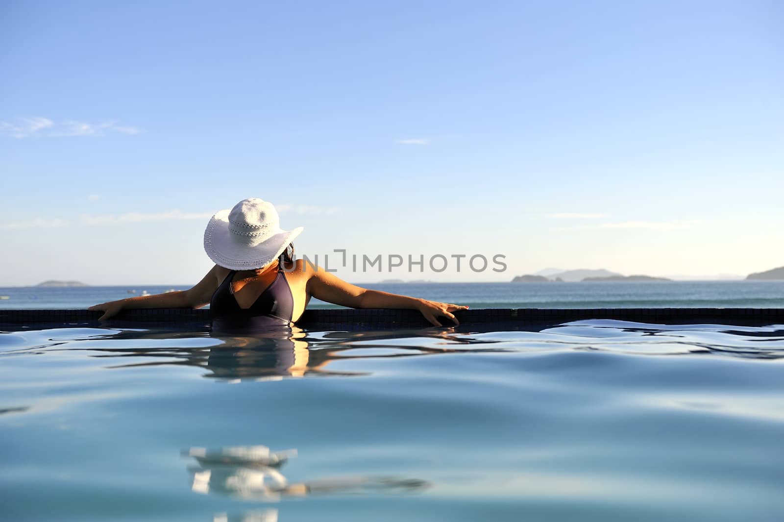 Pretty woman enjoying the swimming pool in Buzios, Brazil