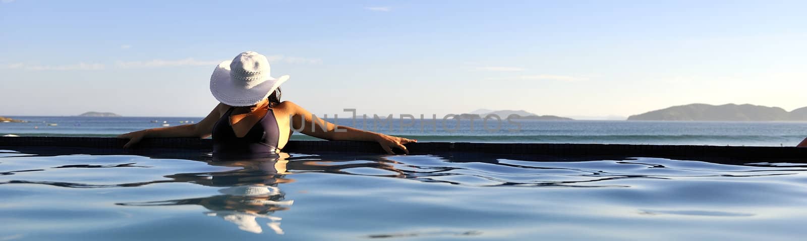 Pretty woman enjoying the swimming pool in Buzios, Brazil