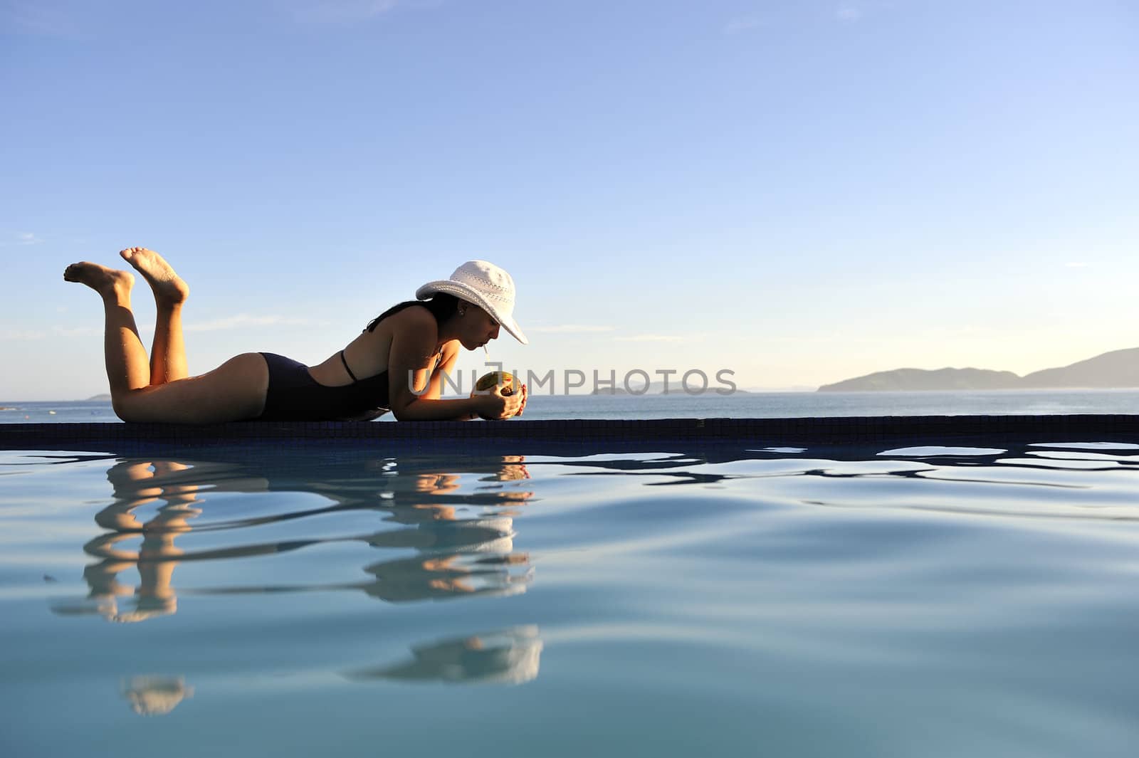 Pretty woman enjoying the swimming pool in Buzios, Brazil