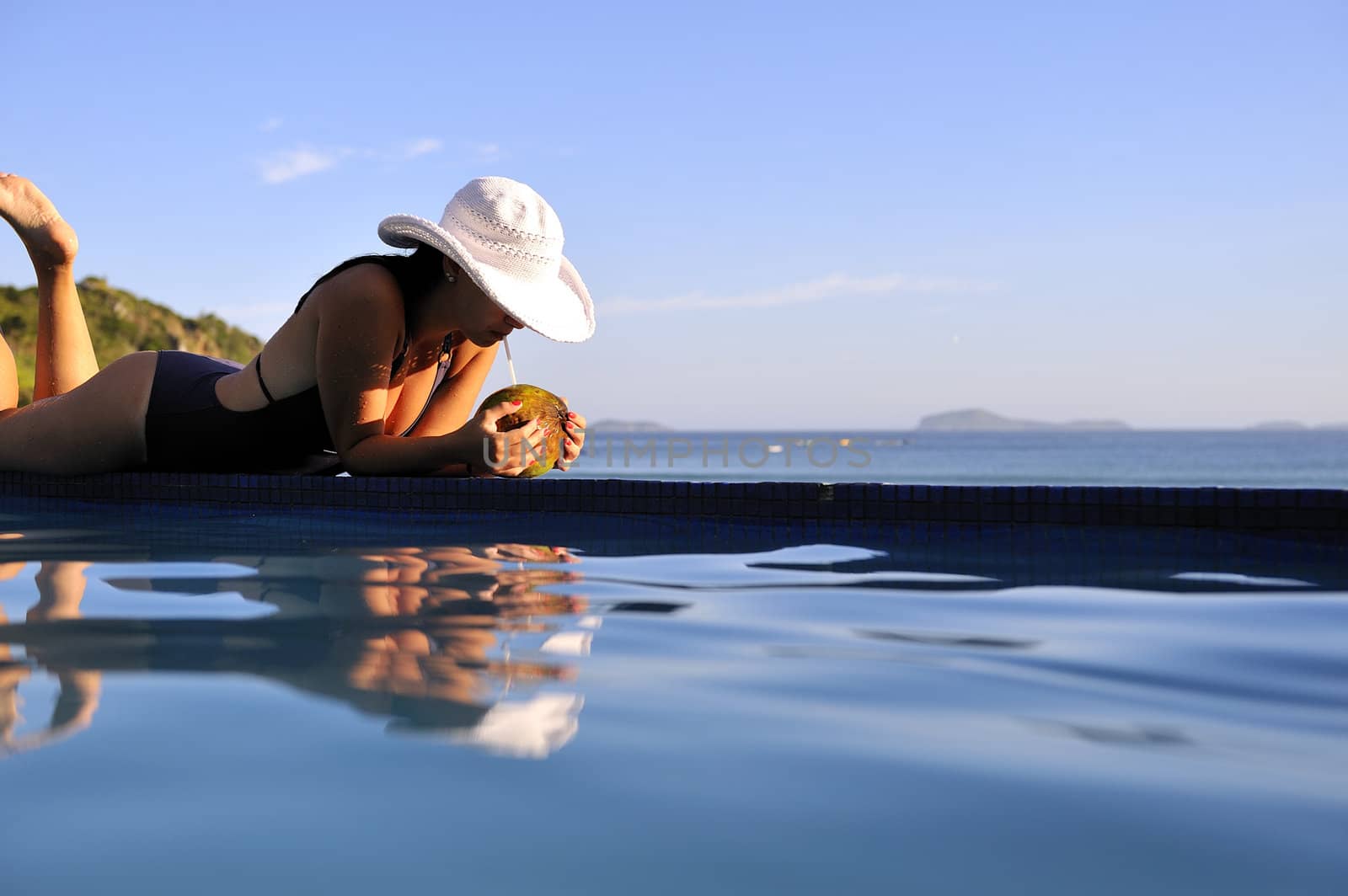 Pretty woman enjoying the swimming pool in Buzios, Brazil