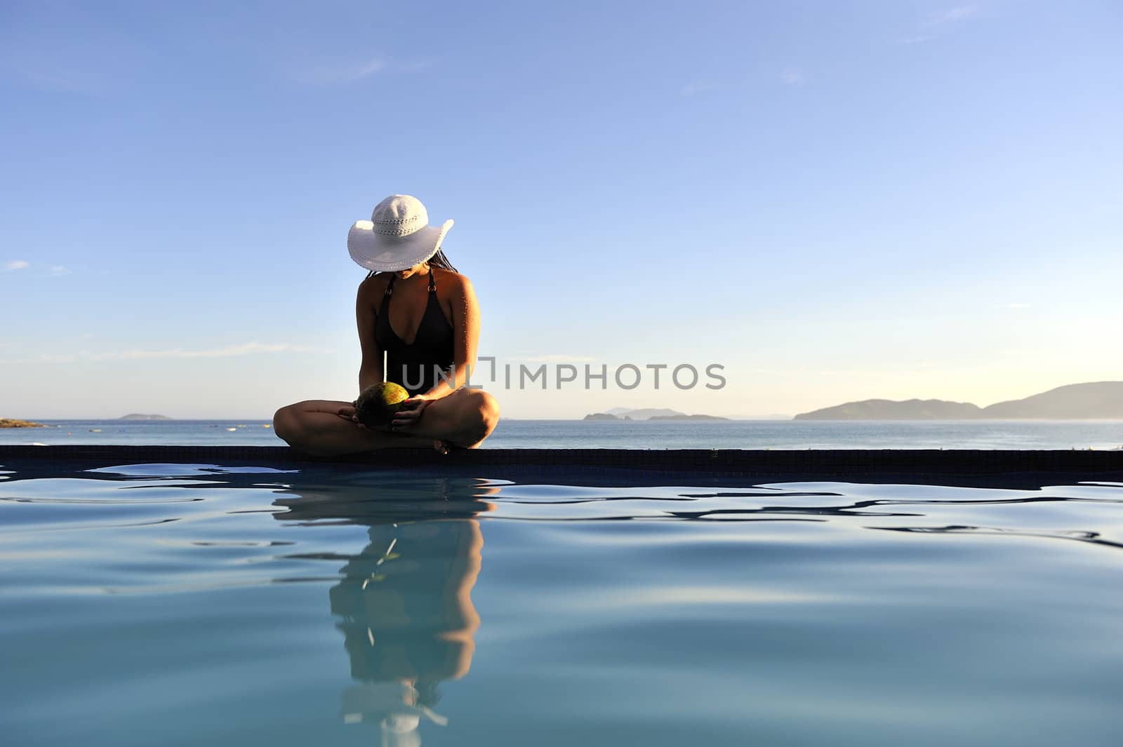 Pretty woman enjoying the swimming pool in Buzios, Brazil