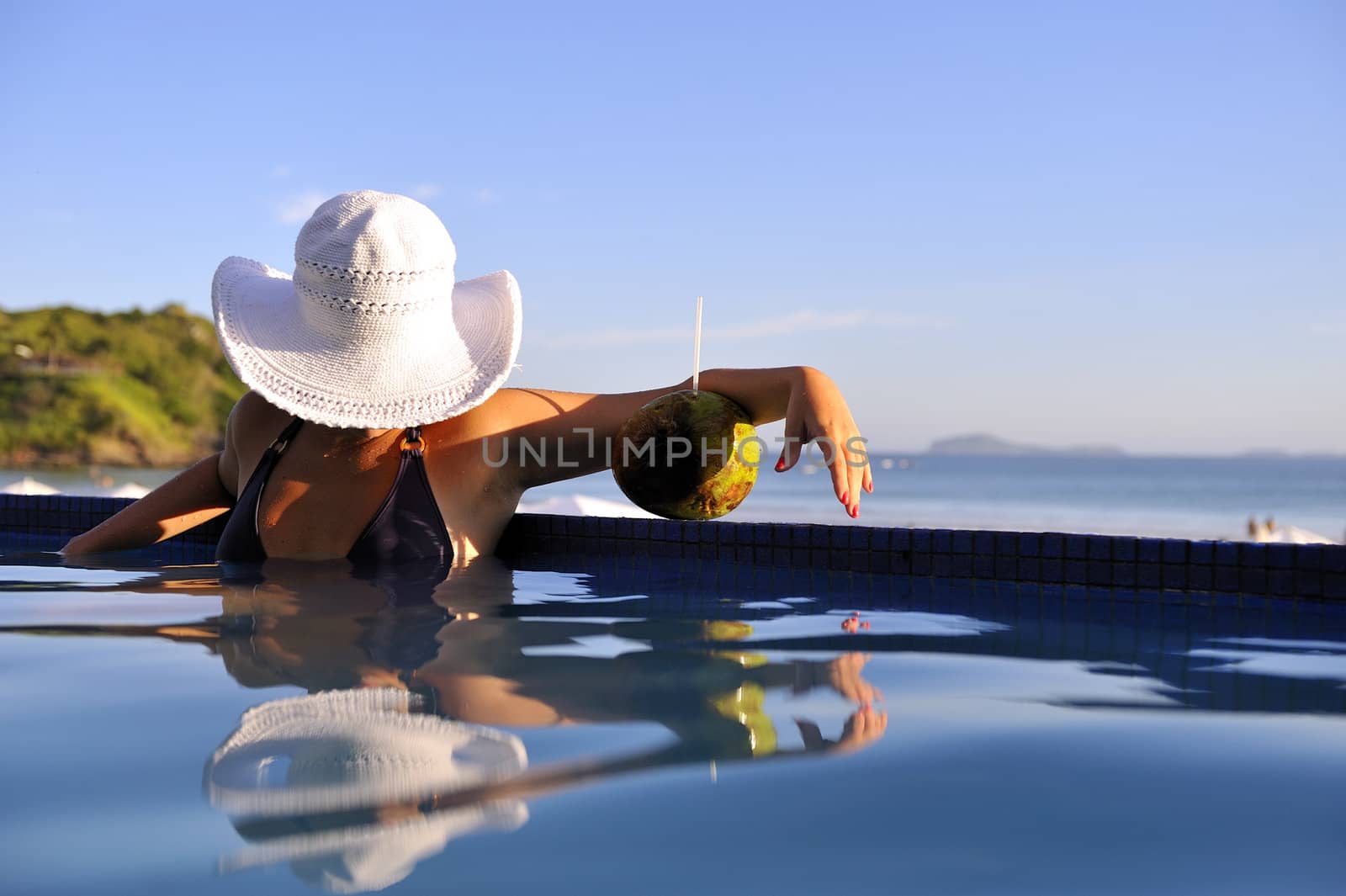 Pretty woman enjoying the swimming pool in Buzios, Brazil