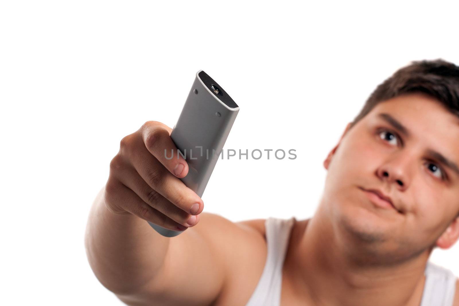 A teenager changes the channel with the remote control isolated over a white background. Shallow depth of field.