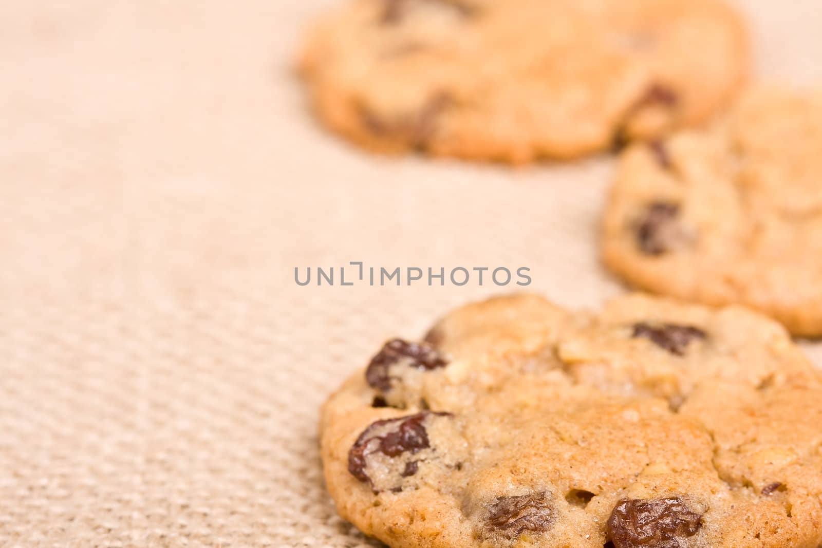 oatmeal raisin cookies on a burlap background macro fresh out of the oven