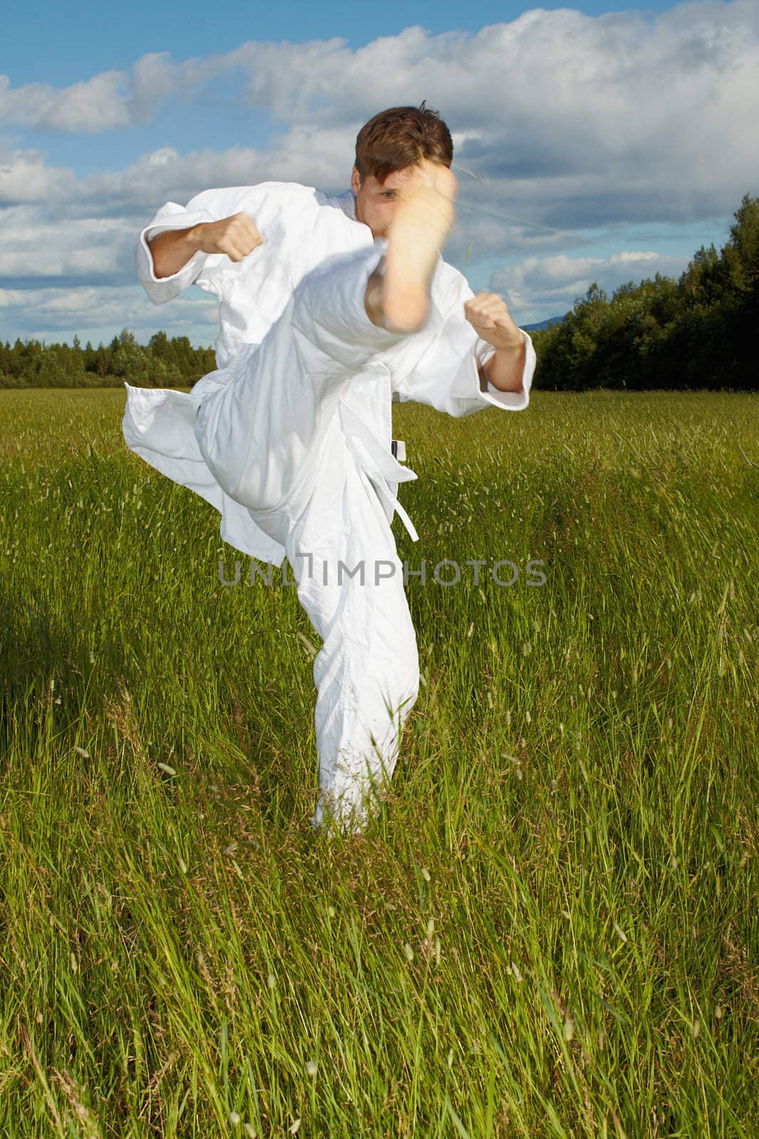 The young man polish a kick - karate