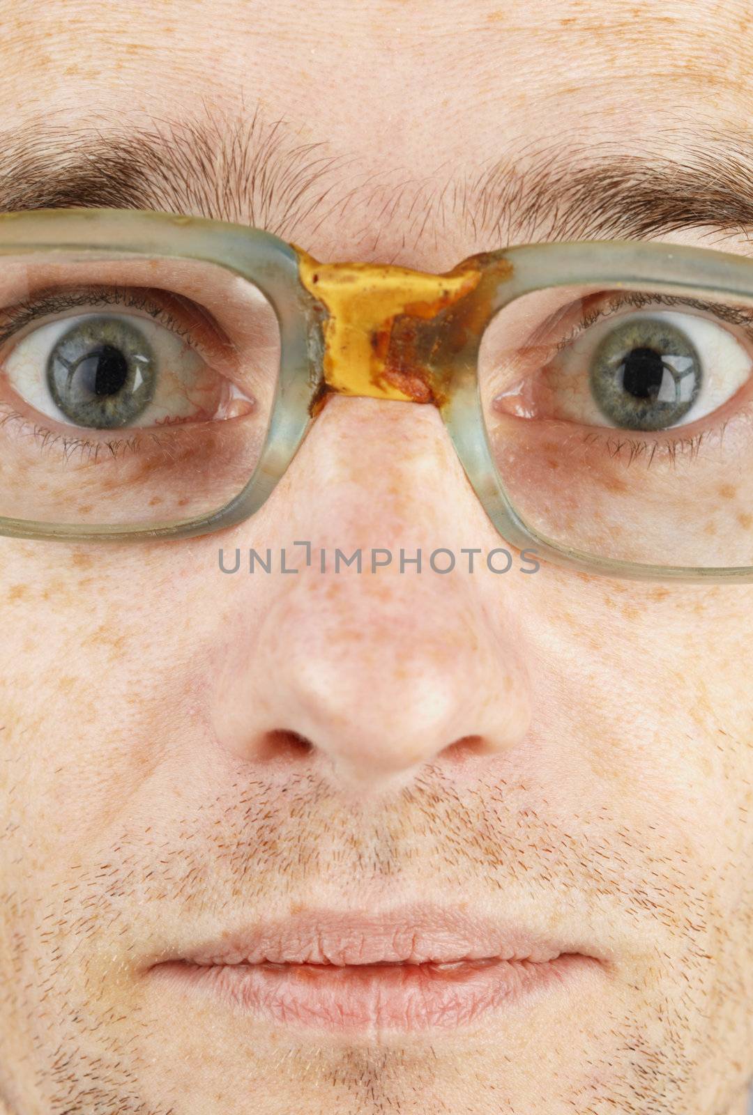 The man's face in the bad old glasses close-up