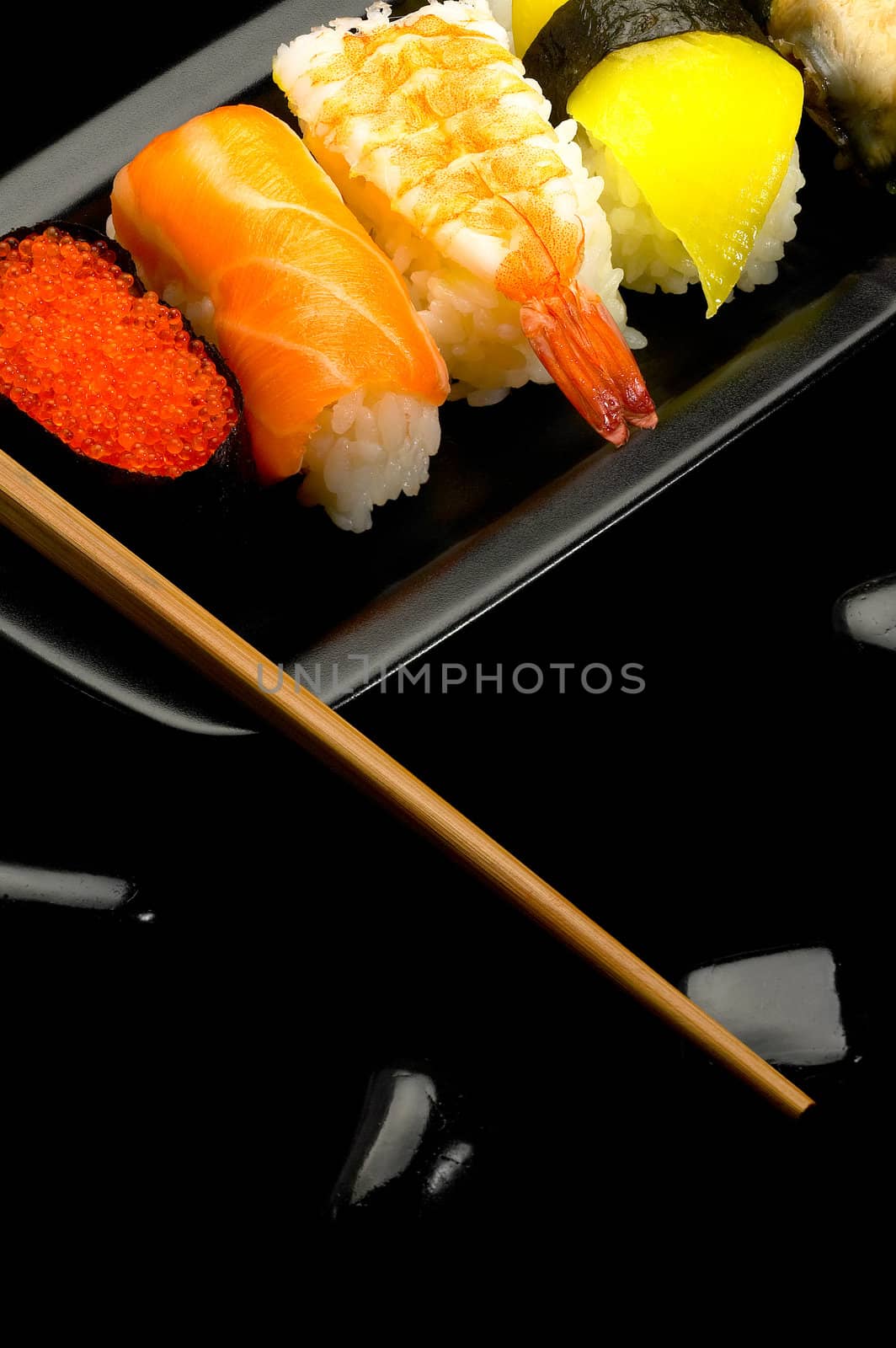 fresh assorted colorfull sushi plate over black