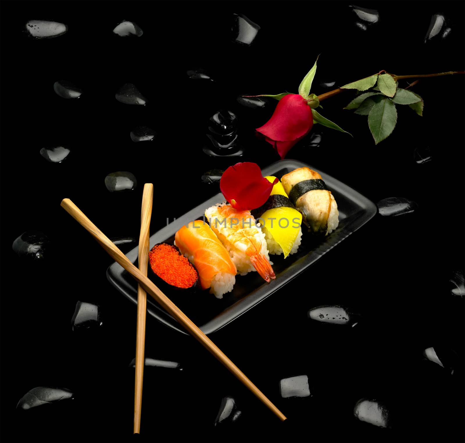 assorted sushi plate on black pebbles over black background by keko64