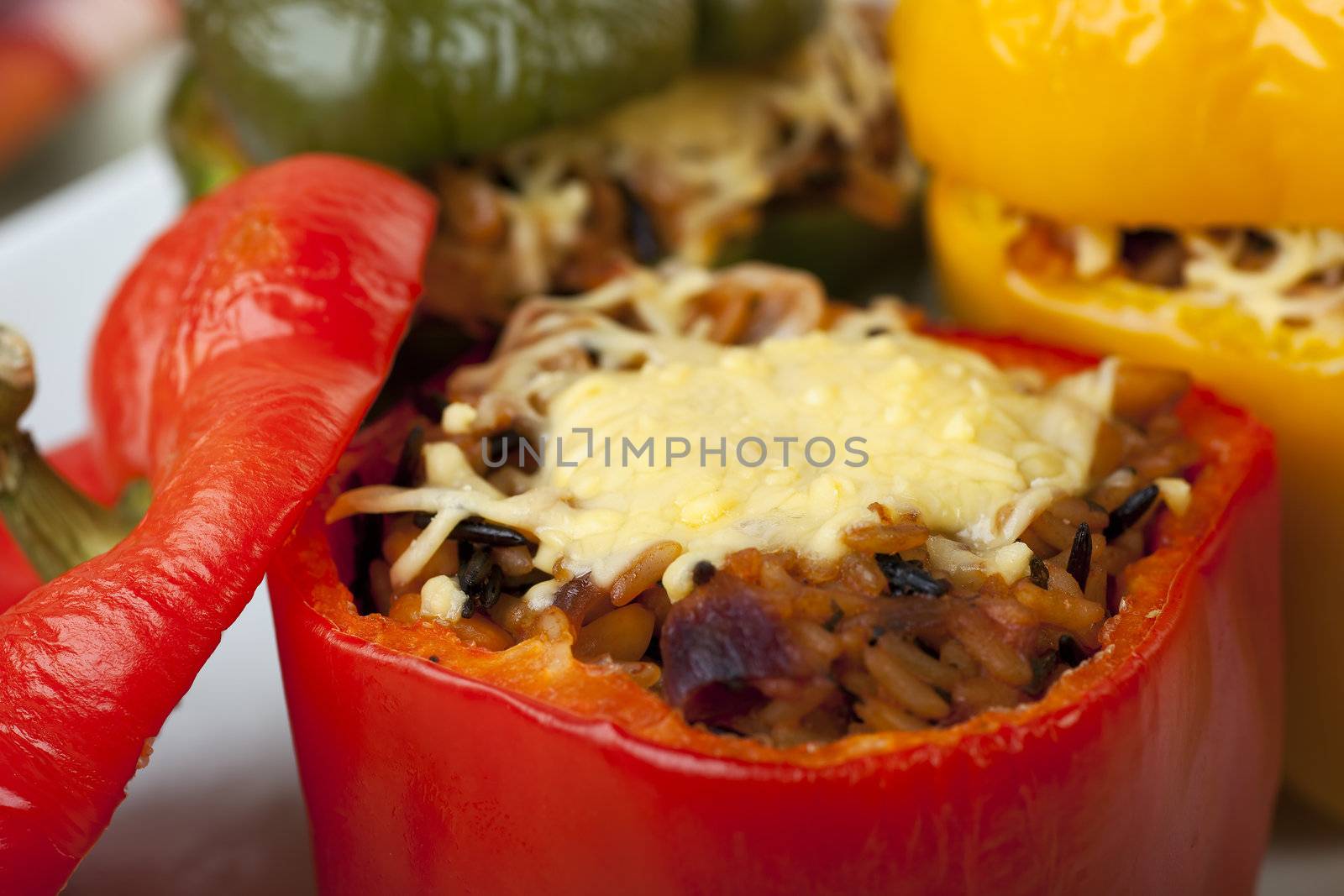 Fresh bell peppers stuffed with wild rice and topped with cheese.