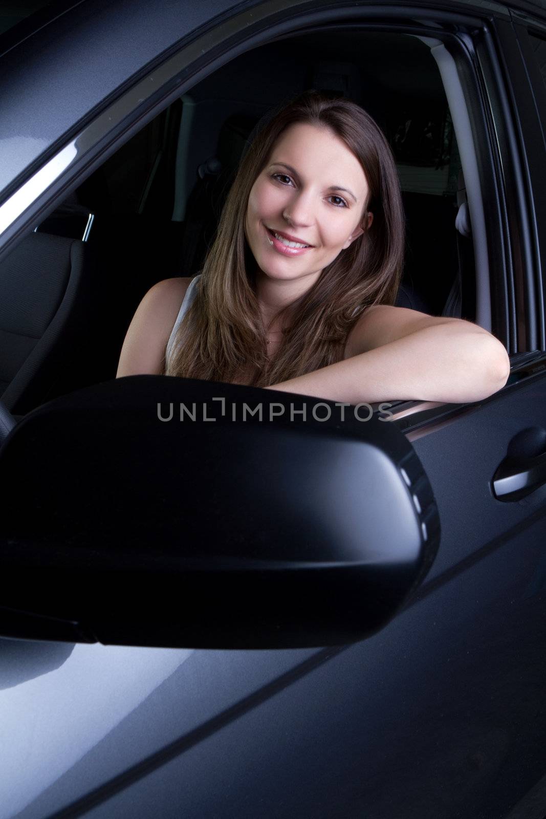 Beautiful smiling woman in car