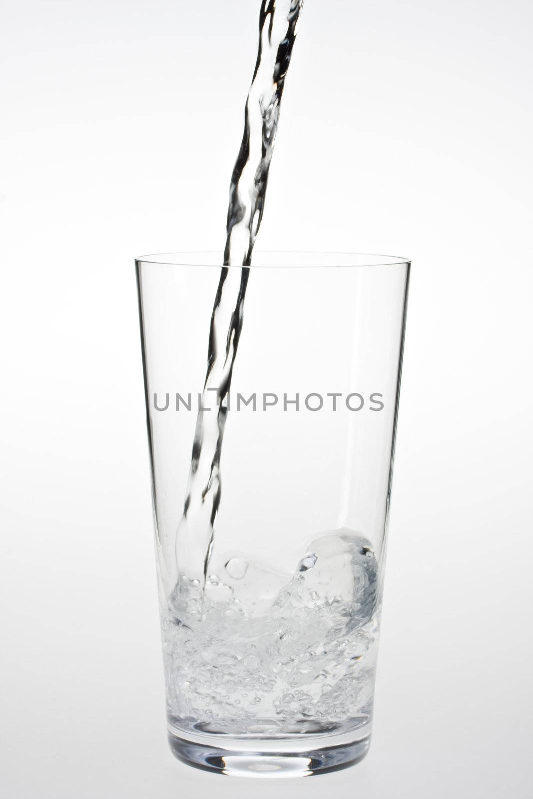 water splashing in a drinking glass by bernjuer