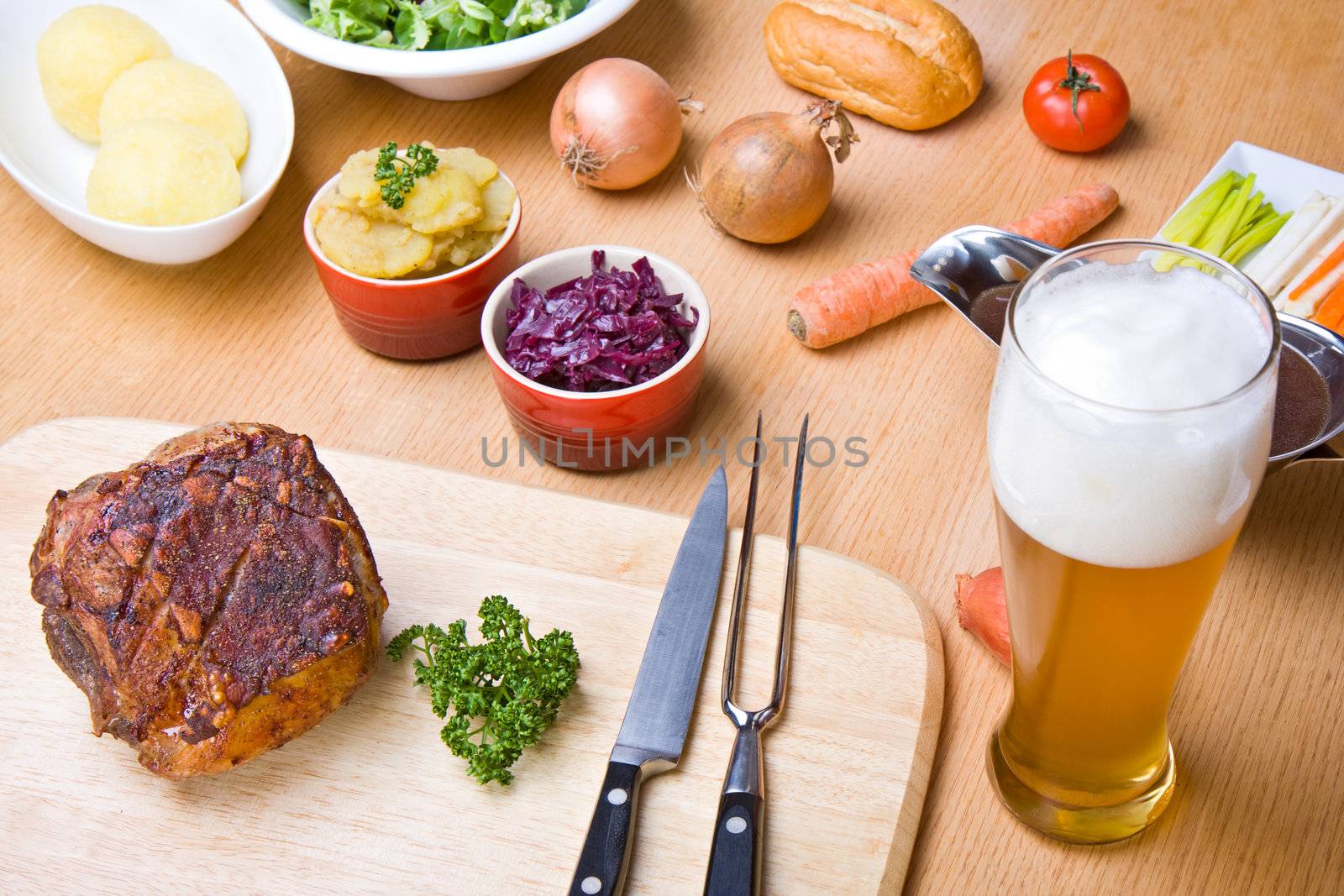 traditional bavarian roast pork with beer sauce and dumplings by bernjuer