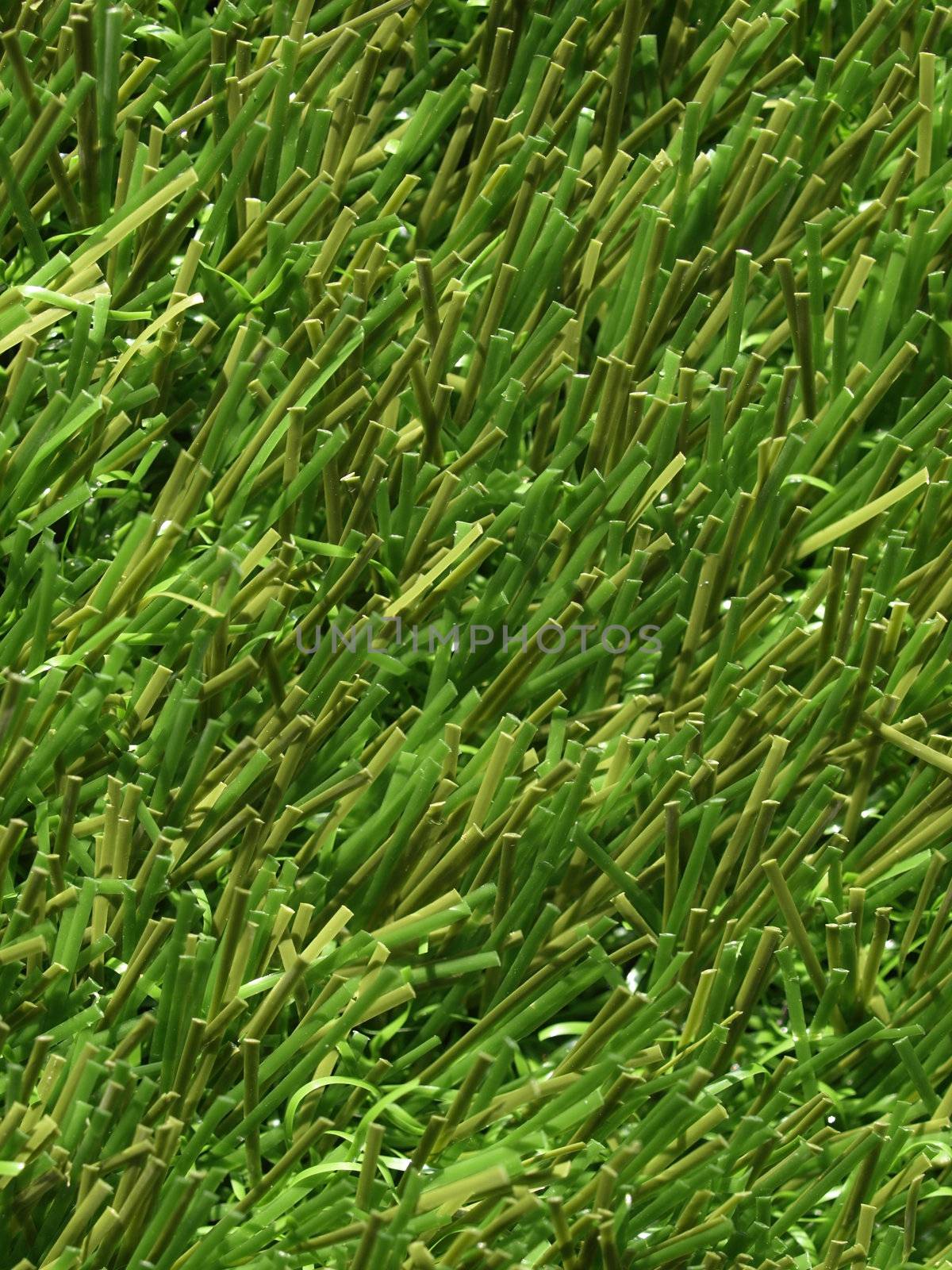 Detail of green grass artificial lawn meadow, useful as a background