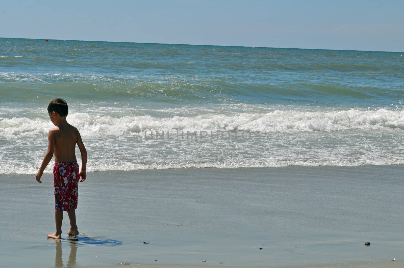 Boy on the beach by RefocusPhoto