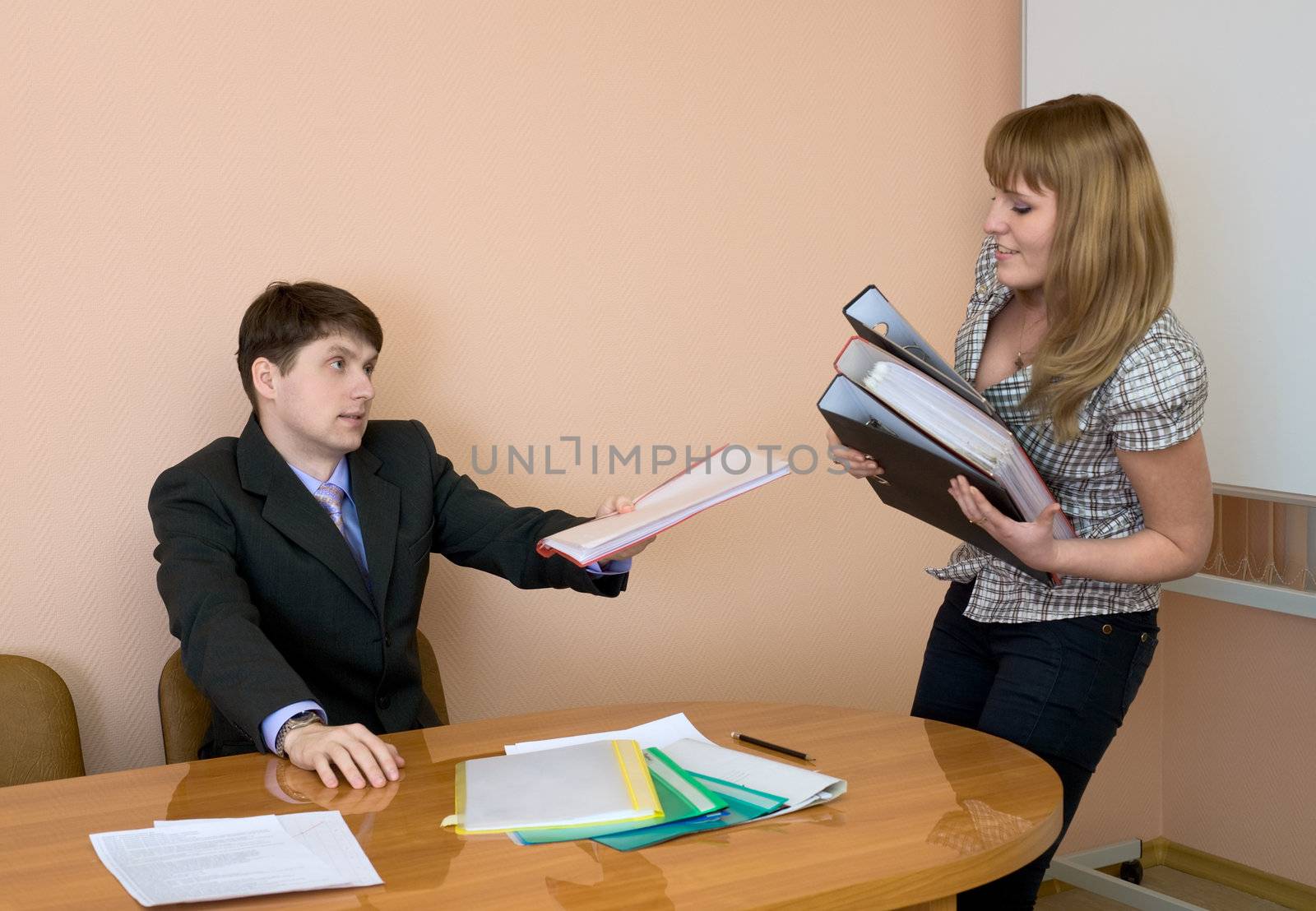 The secretary gives a folders to the chief