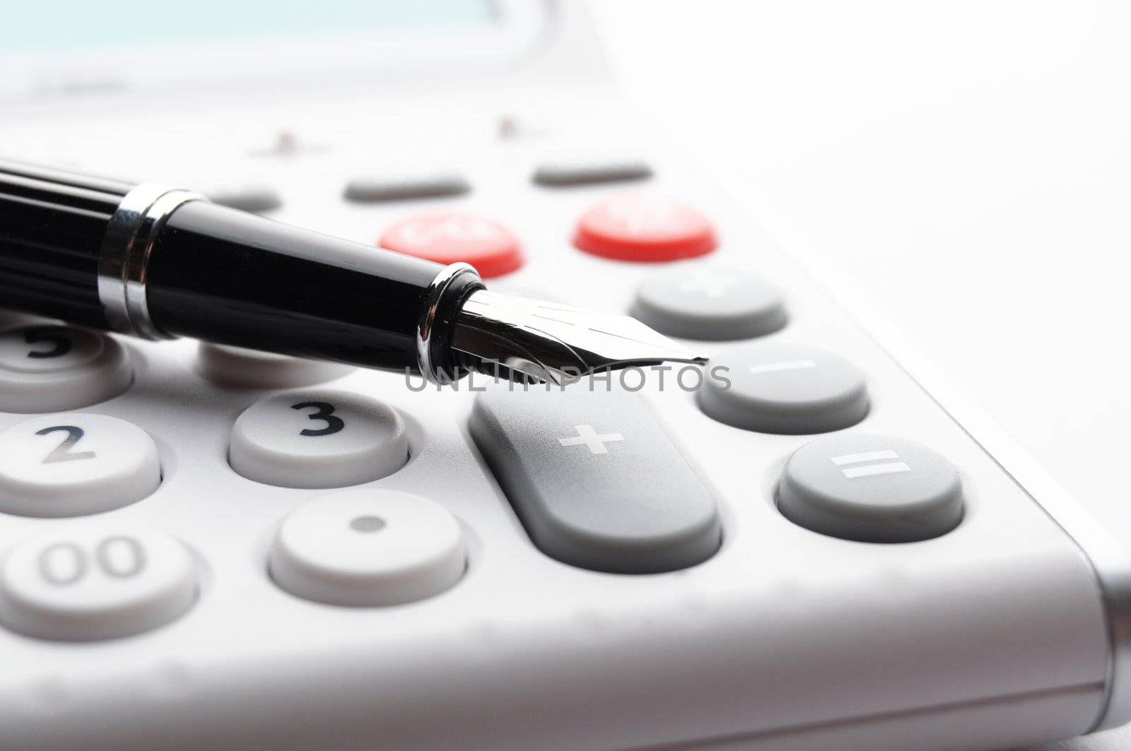 accounting concept with calculator and pen in business office