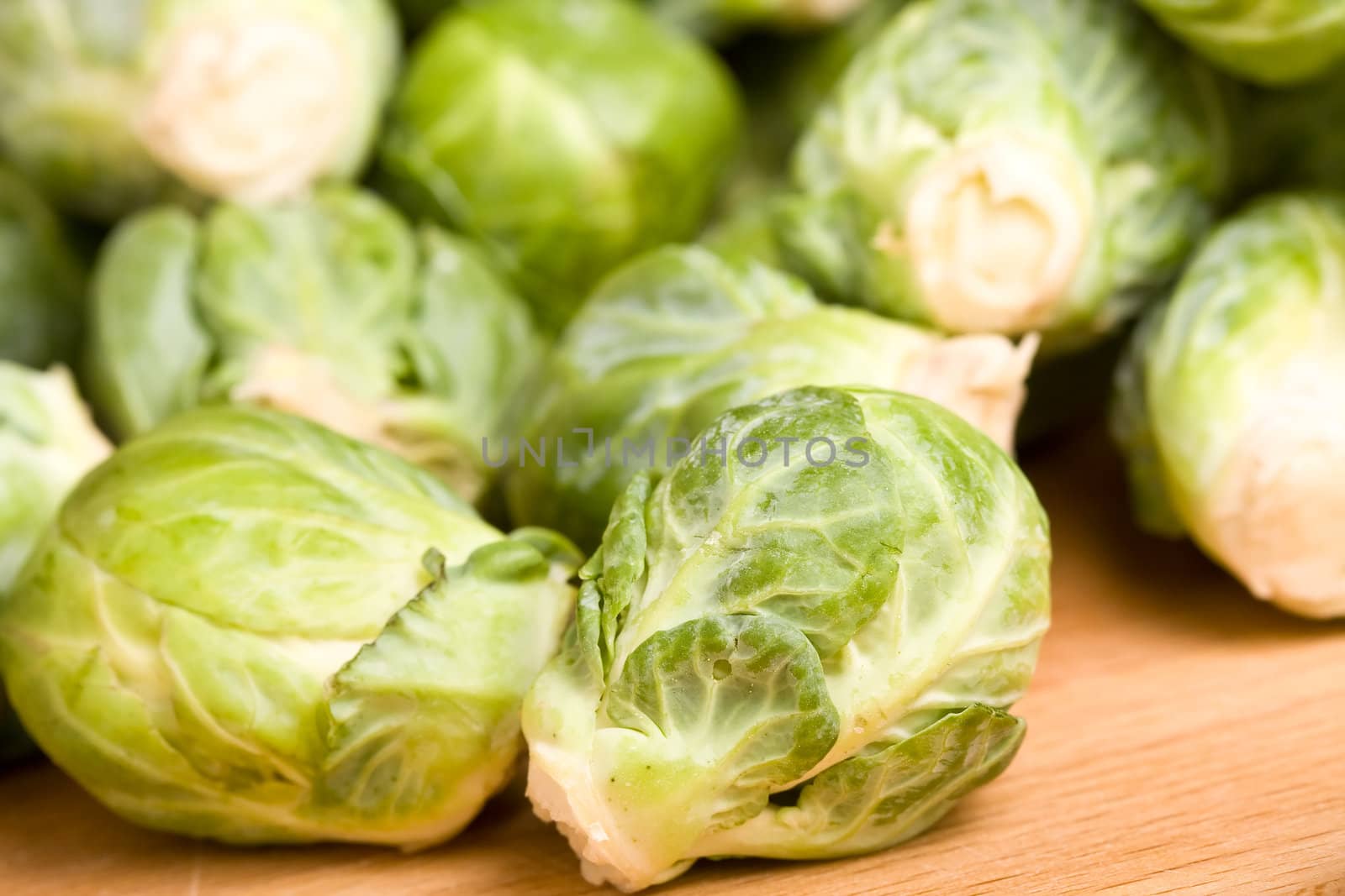 close up of brussel sprouts on a wood cutting block