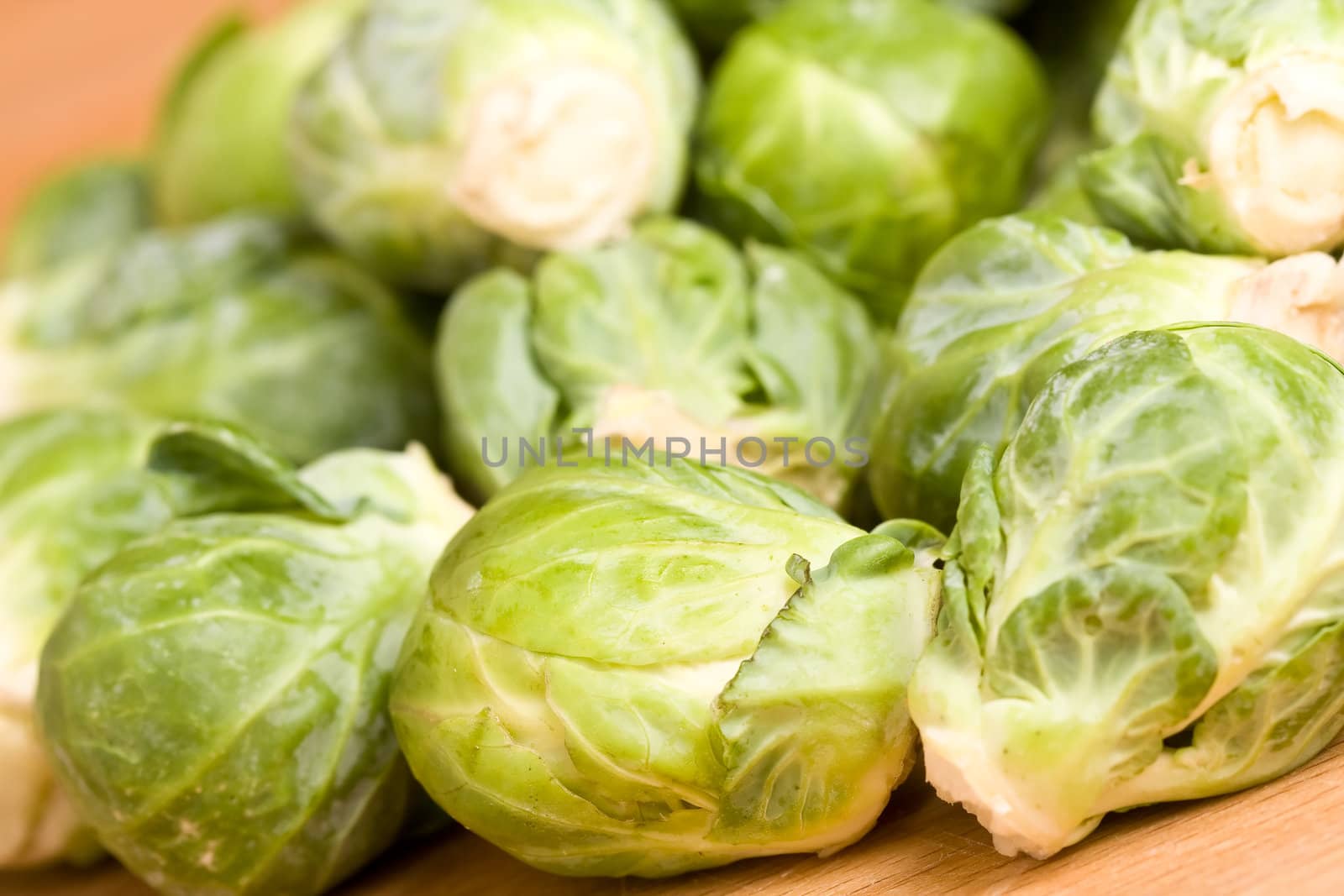 close up of brussel sprouts on a wood cutting block