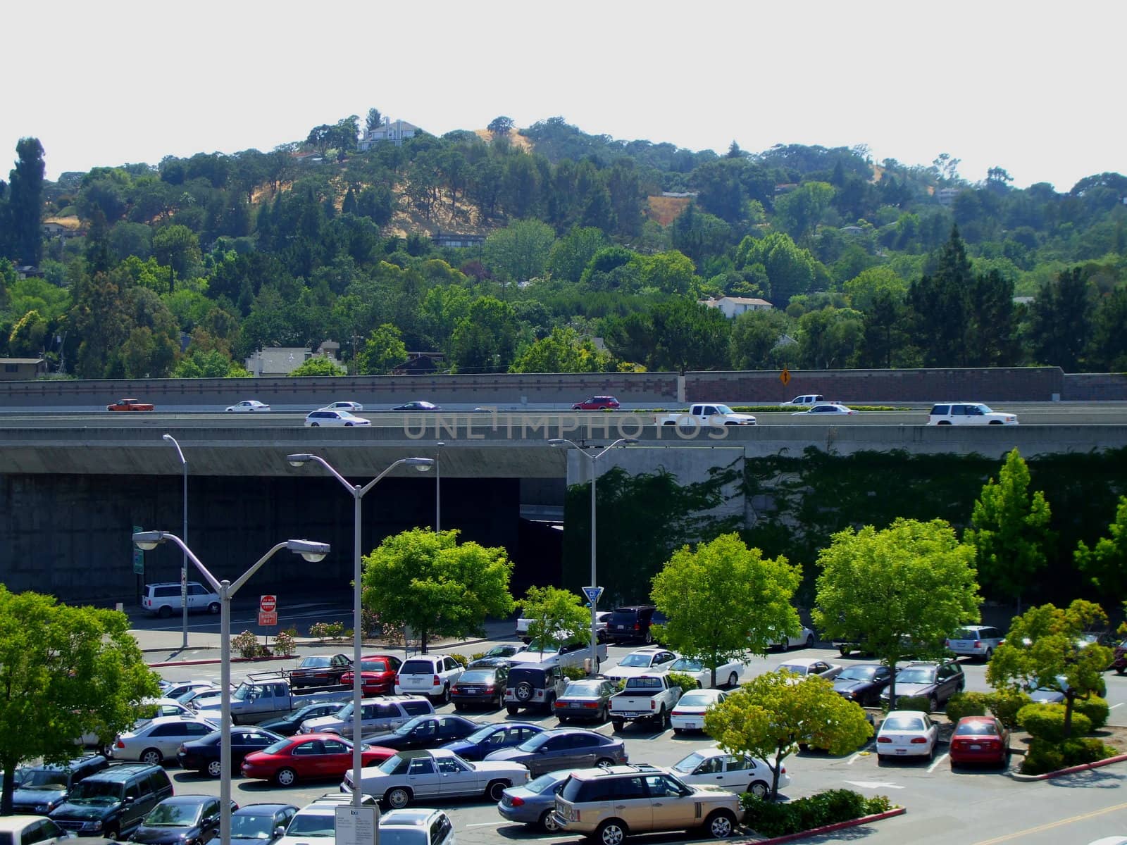 A big parking lot filled with many cars.