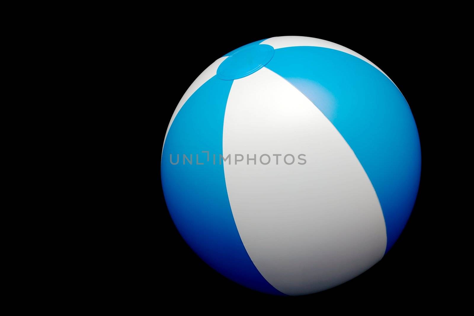Striped beach ball isolated on black background