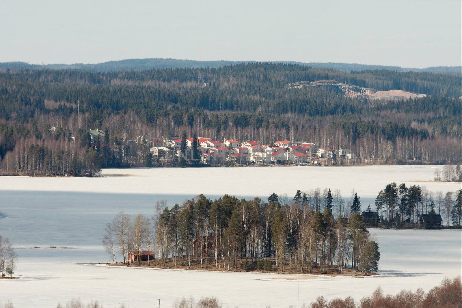 Landscape in Finland with hills and frozen lake