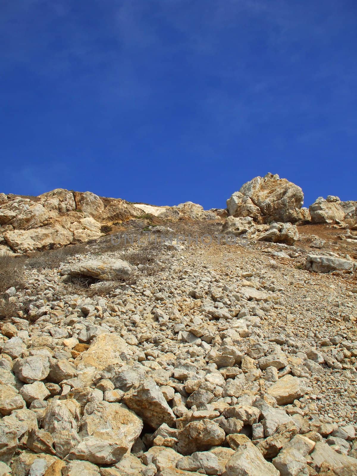 Tall mountain on a sunny day over blue sky.