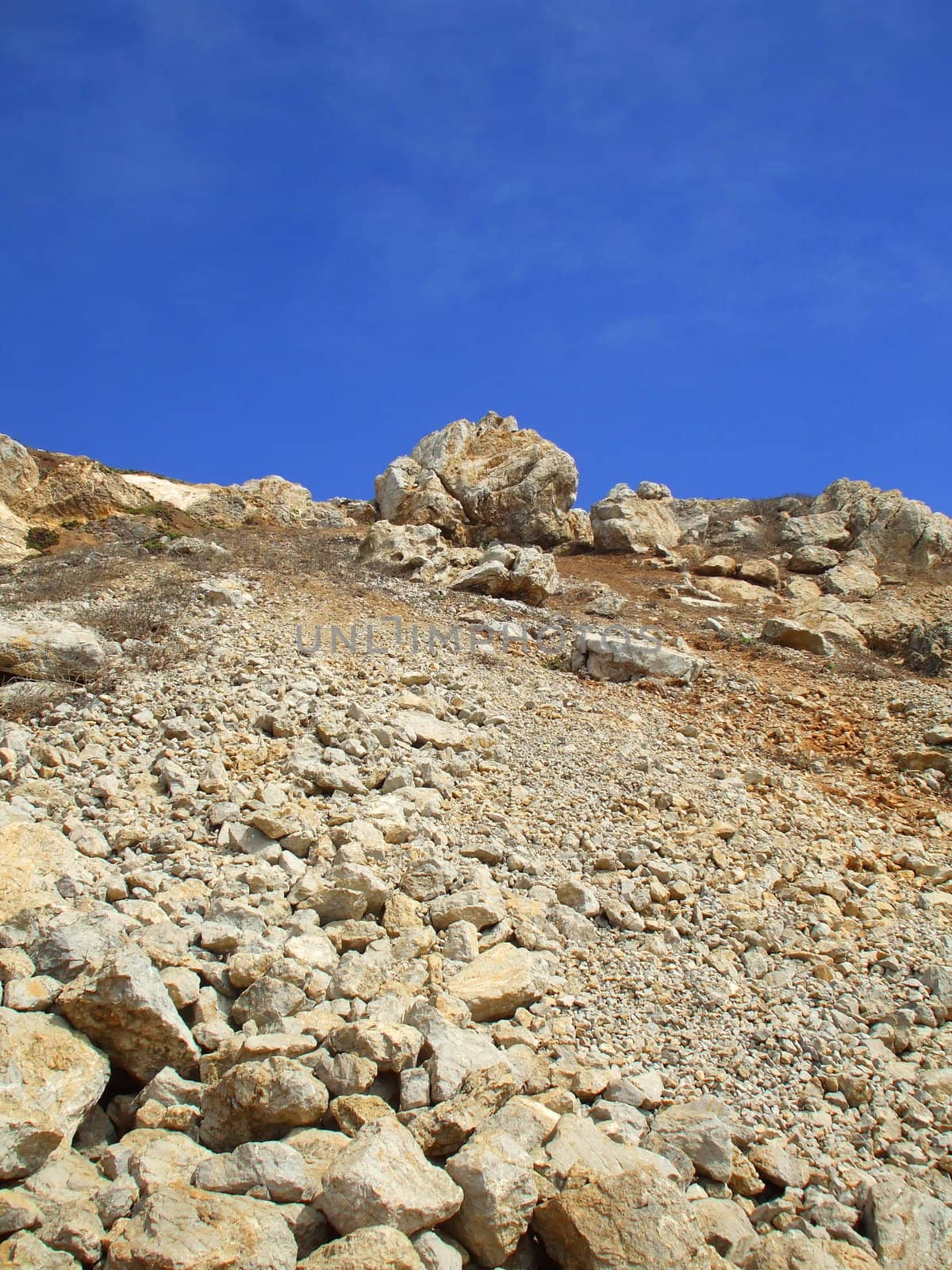 Tall mountain on a sunny day over blue sky.