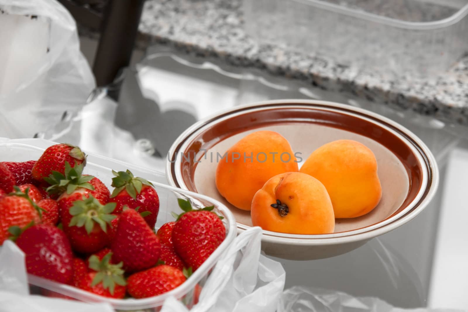 Peaches and strawberries on a table