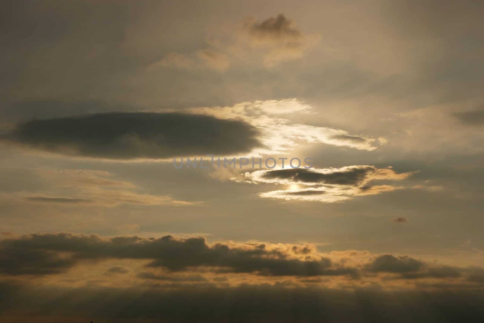 Glowing cloudy sky with rays of light