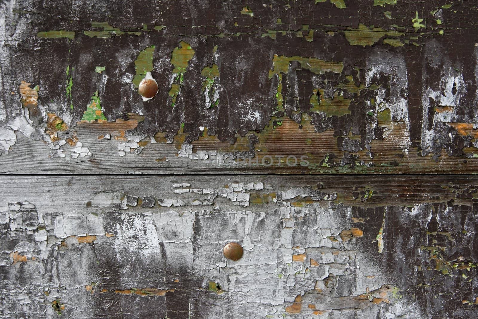 Grainy texture of an old wooden structure, with painting falling apart