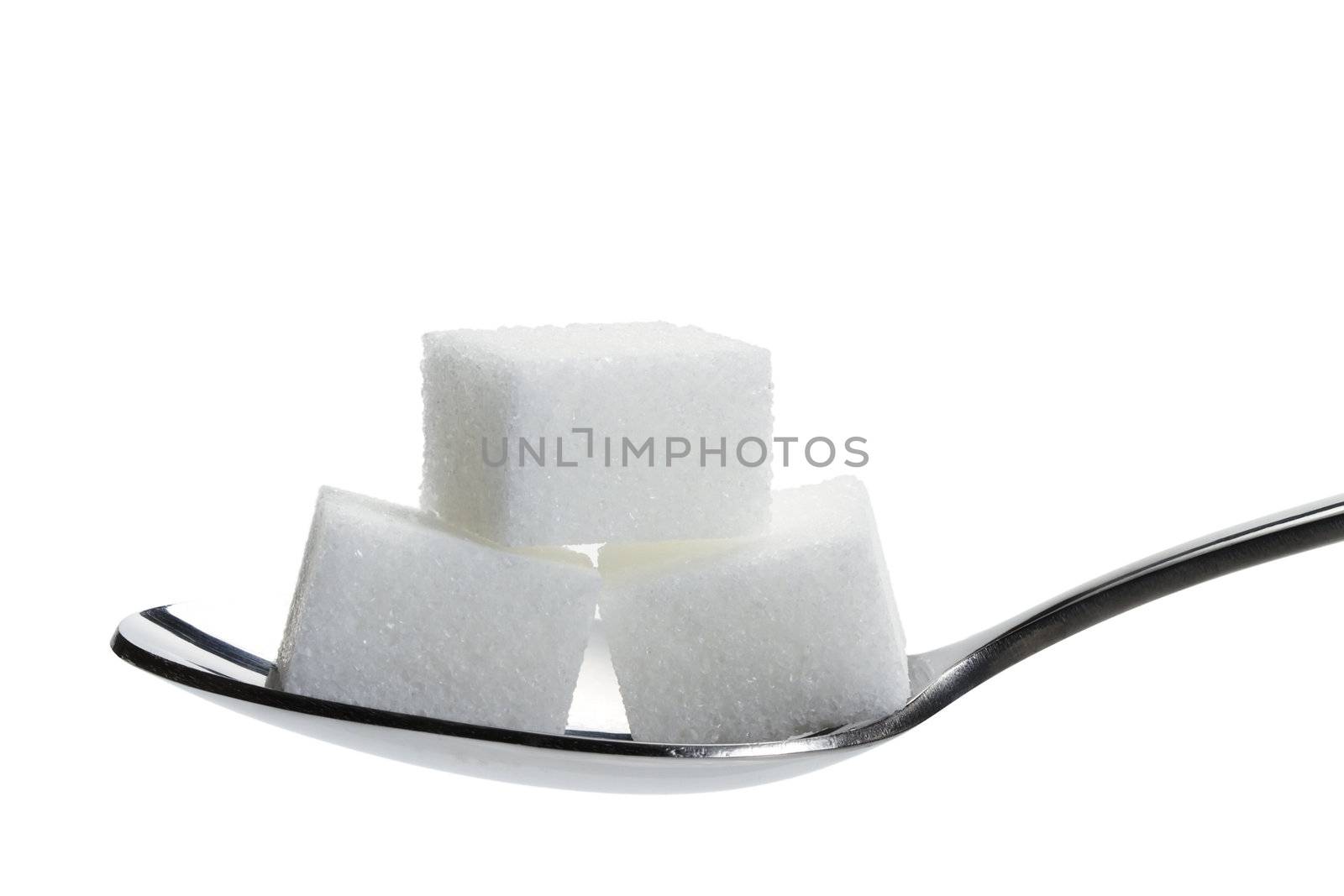 three lump sugar on a spoon isolated on white background