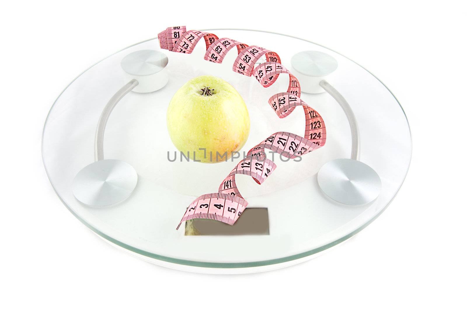 Scale, tape and green apple on white background