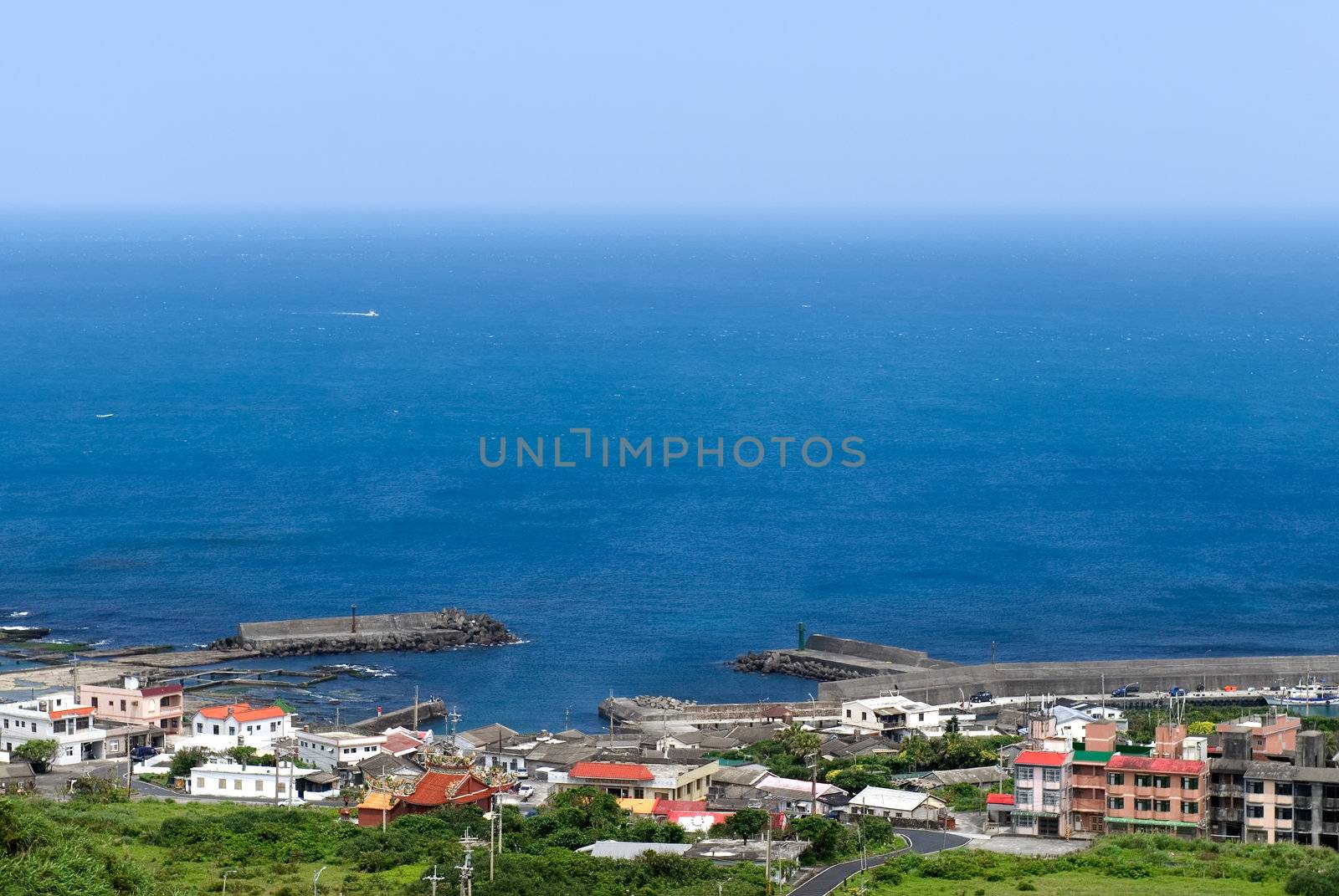 It is a beautiful seascape of small town and blue sea water.