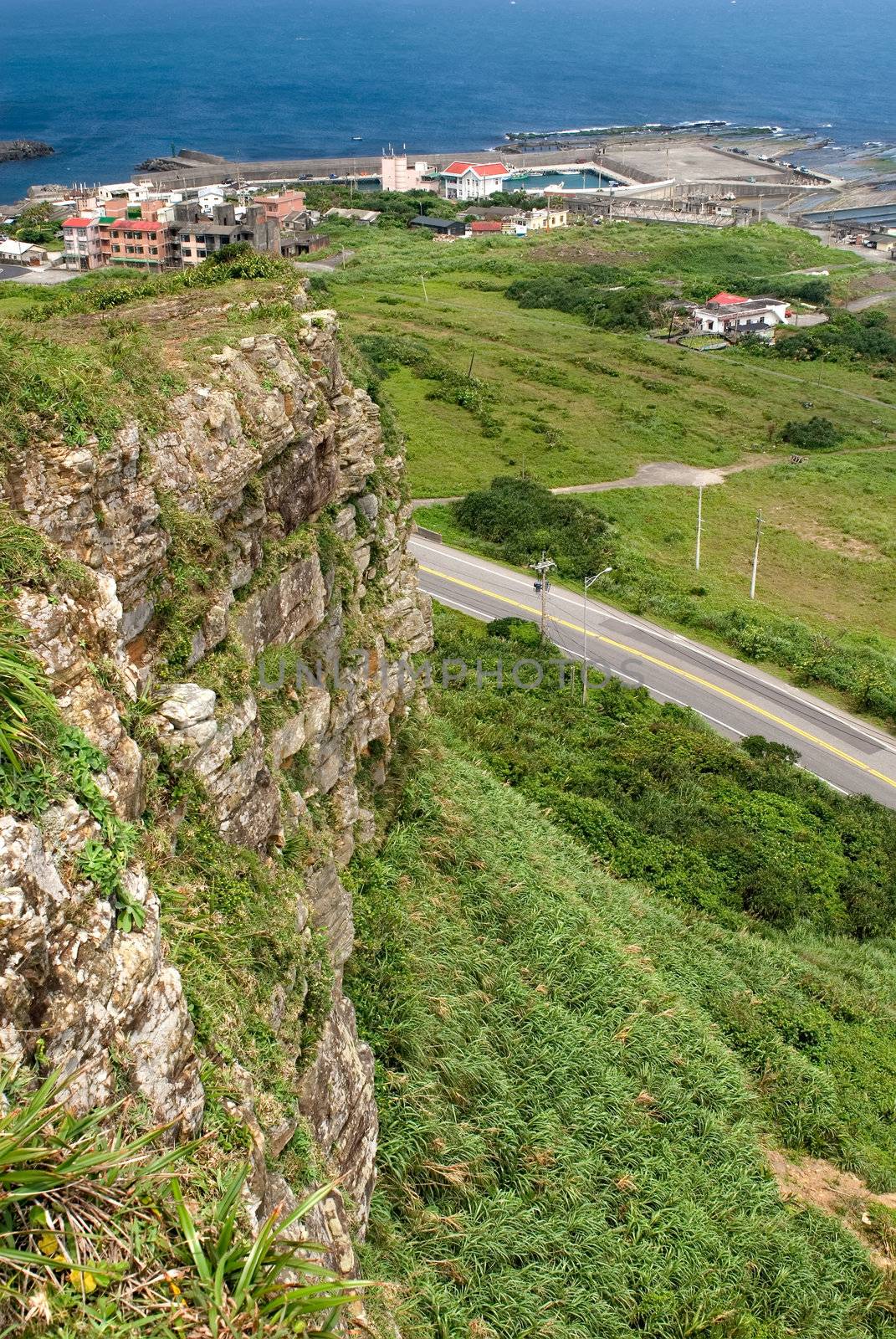 It is a green cliff and small town near the sea.