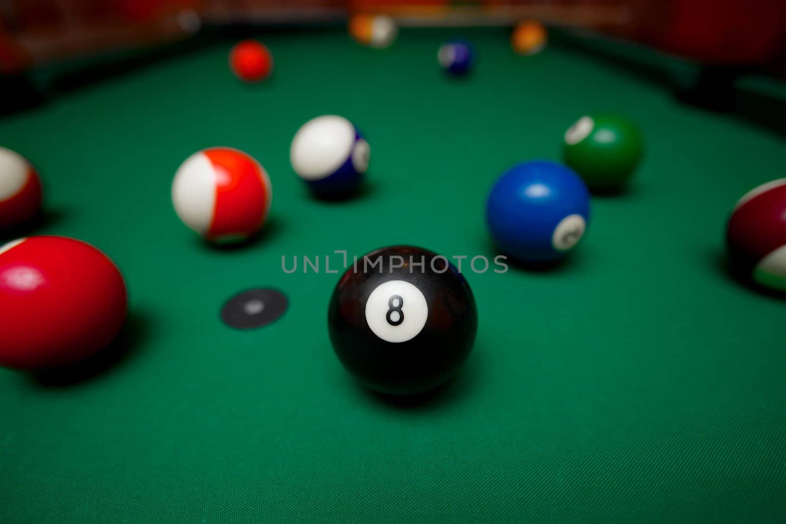 Pool table with the black ball in the middle