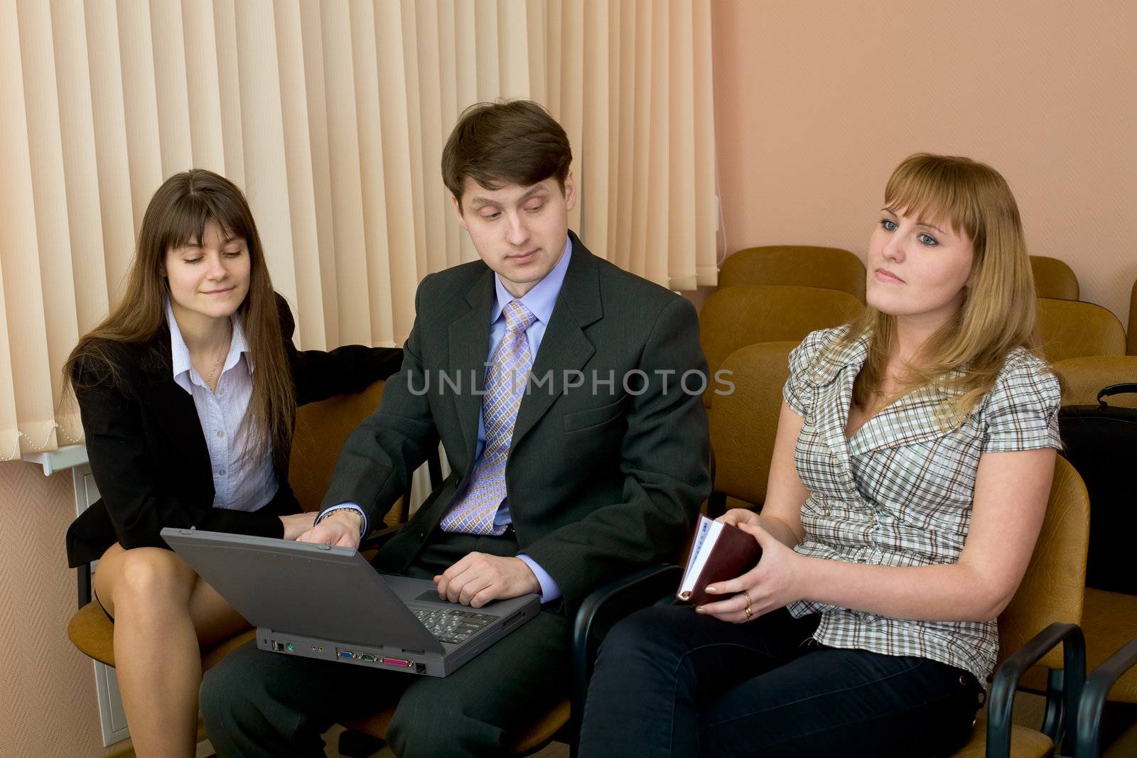 Group of businessmen sitting on armchairs at conference