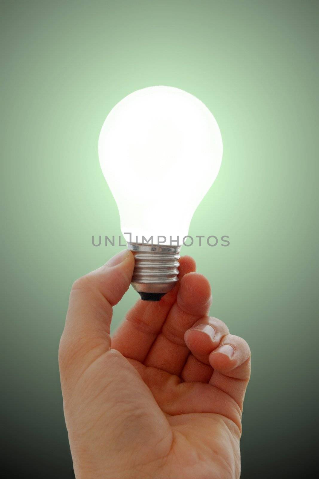 Glowing lightbulb in hand