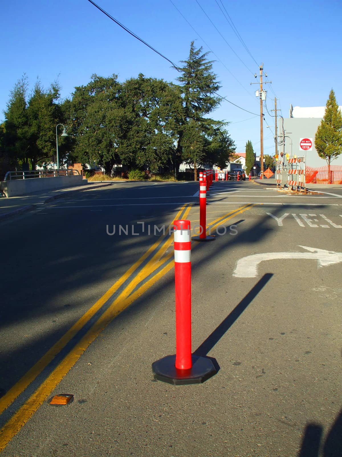 A row of road cones next to a construction site.