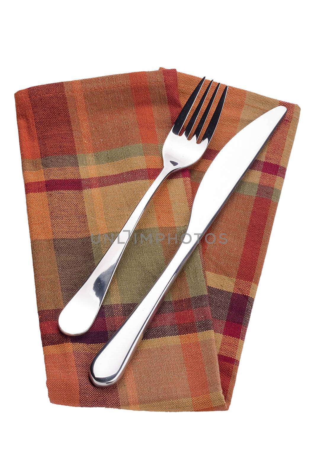 Knife and fork on a red napkin - tableware.