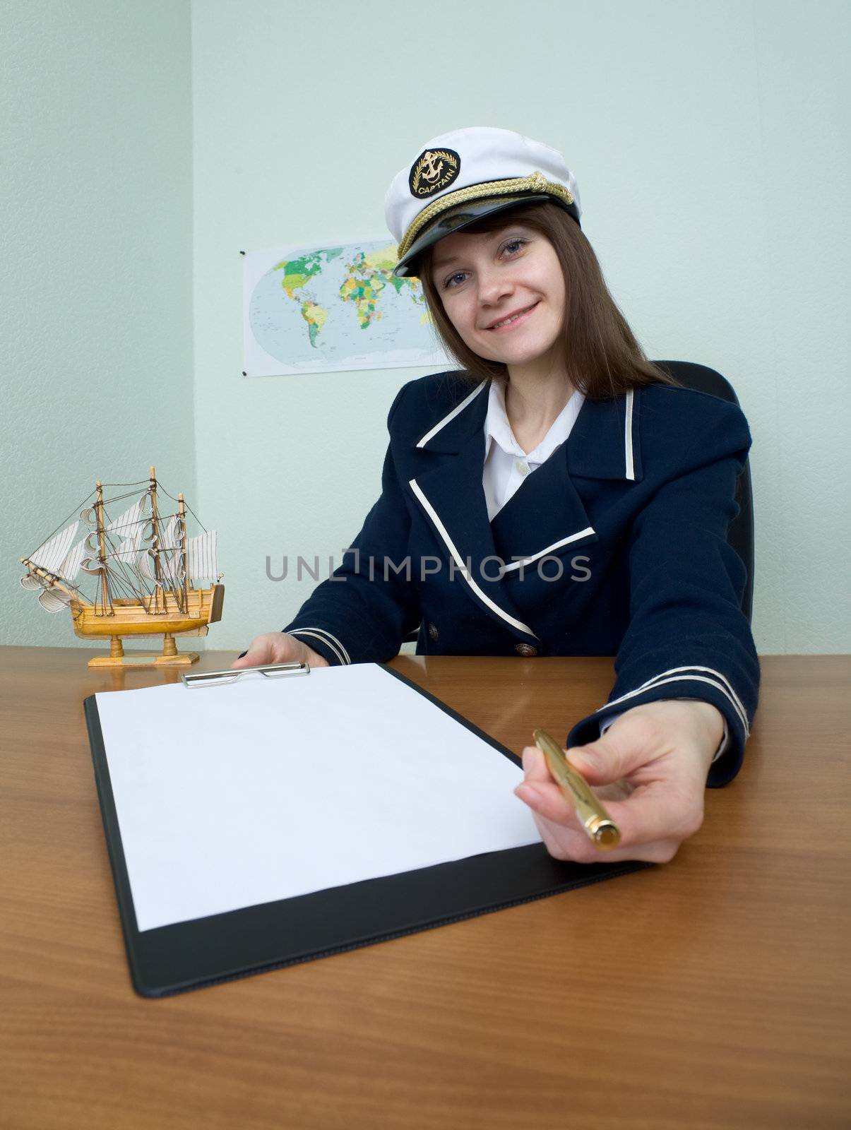 The woman in a sea uniform at table with tablet