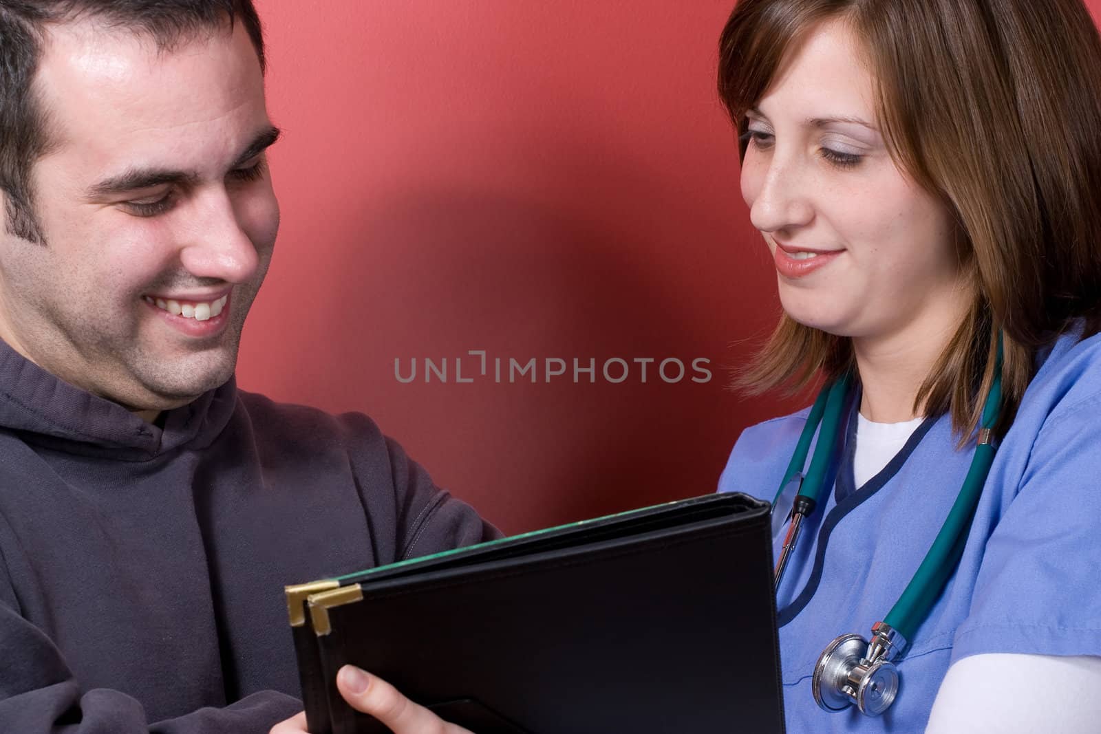 A young nurse sharing results with her patient during his visit.
