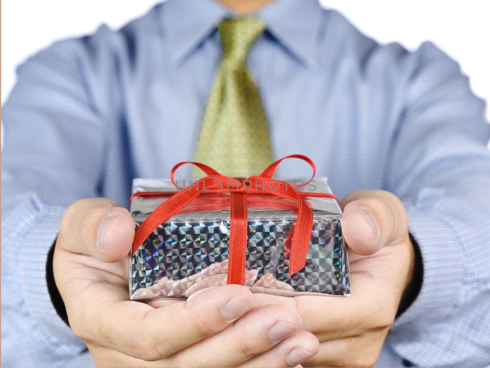 Office guy holding a gift with a red satin bow.