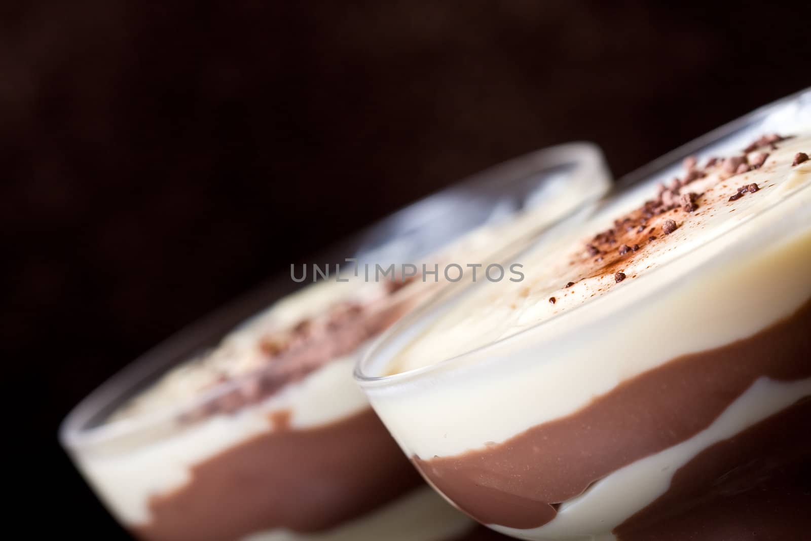 chocolate and vanilla pudding in a parfait glass dusting of chocolate on top