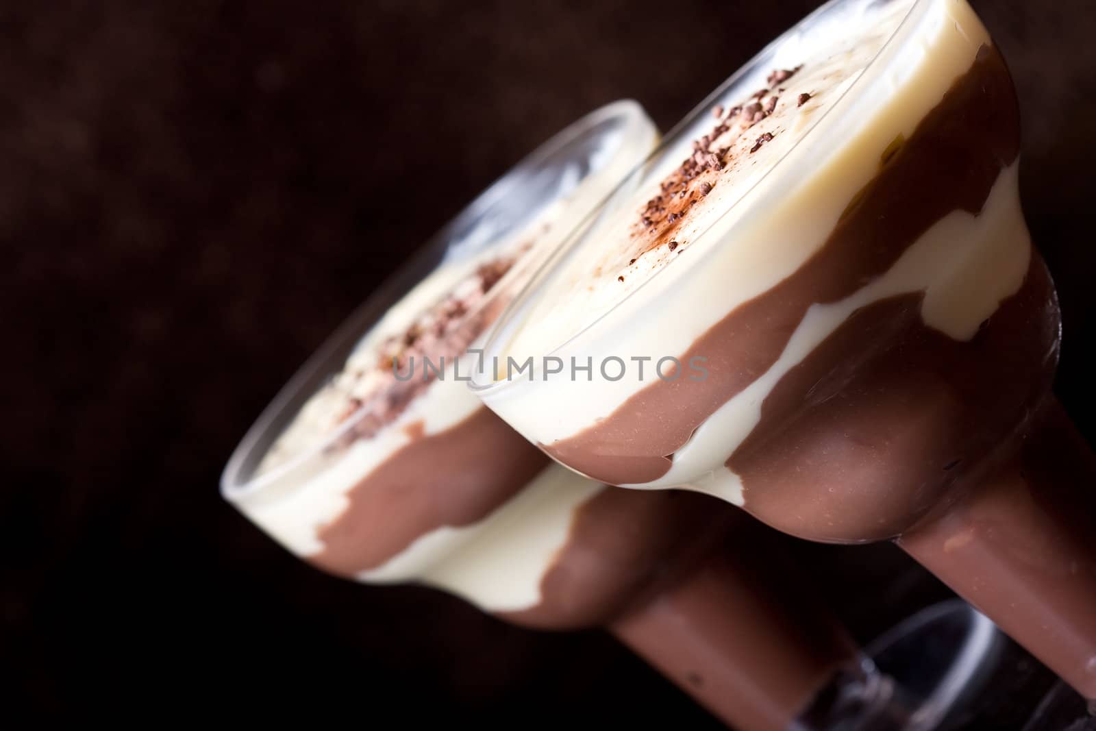 chocolate and vanilla pudding in a parfait glass dusting of chocolate on top