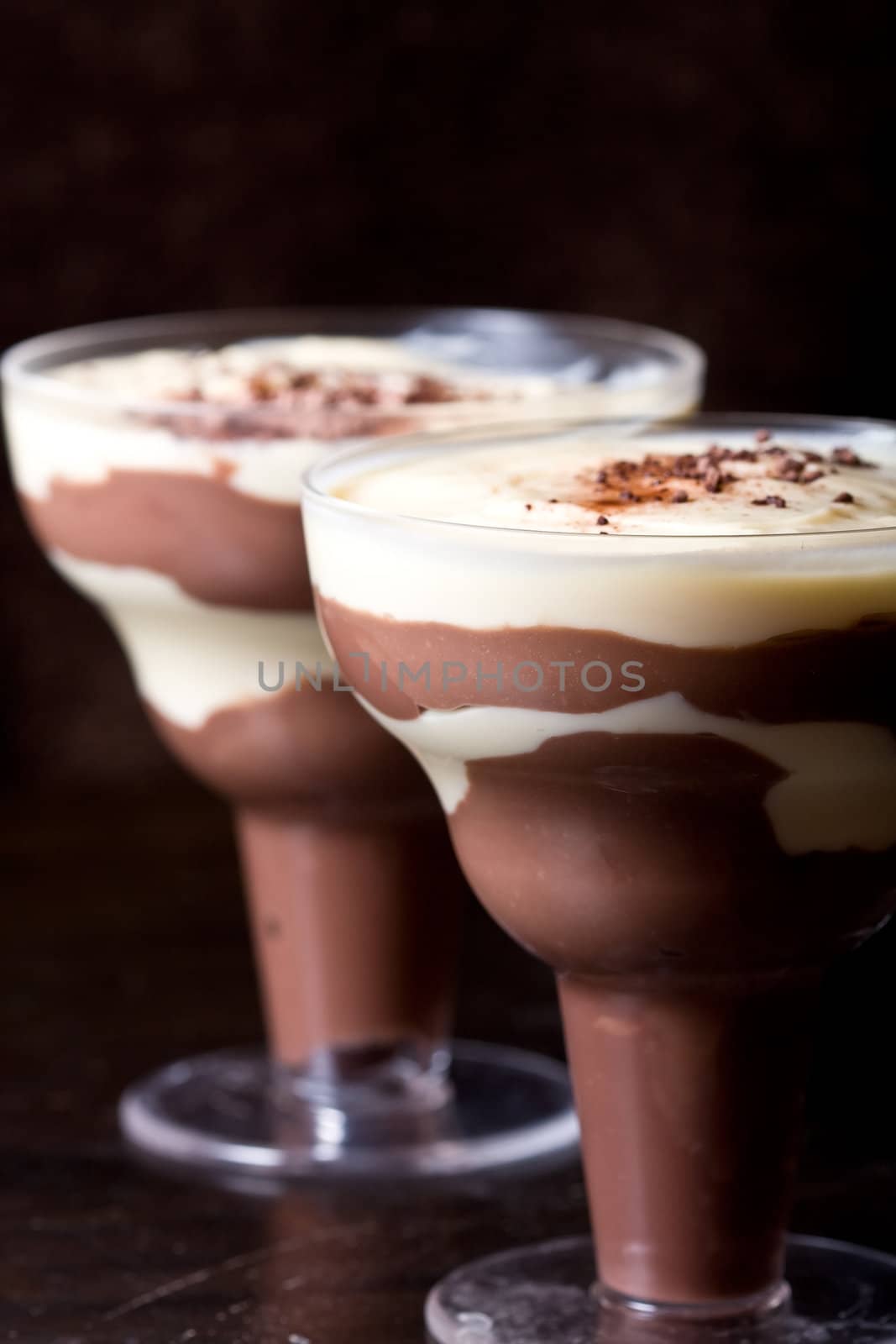 chocolate and vanilla pudding in a parfait glass dusting of chocolate on top