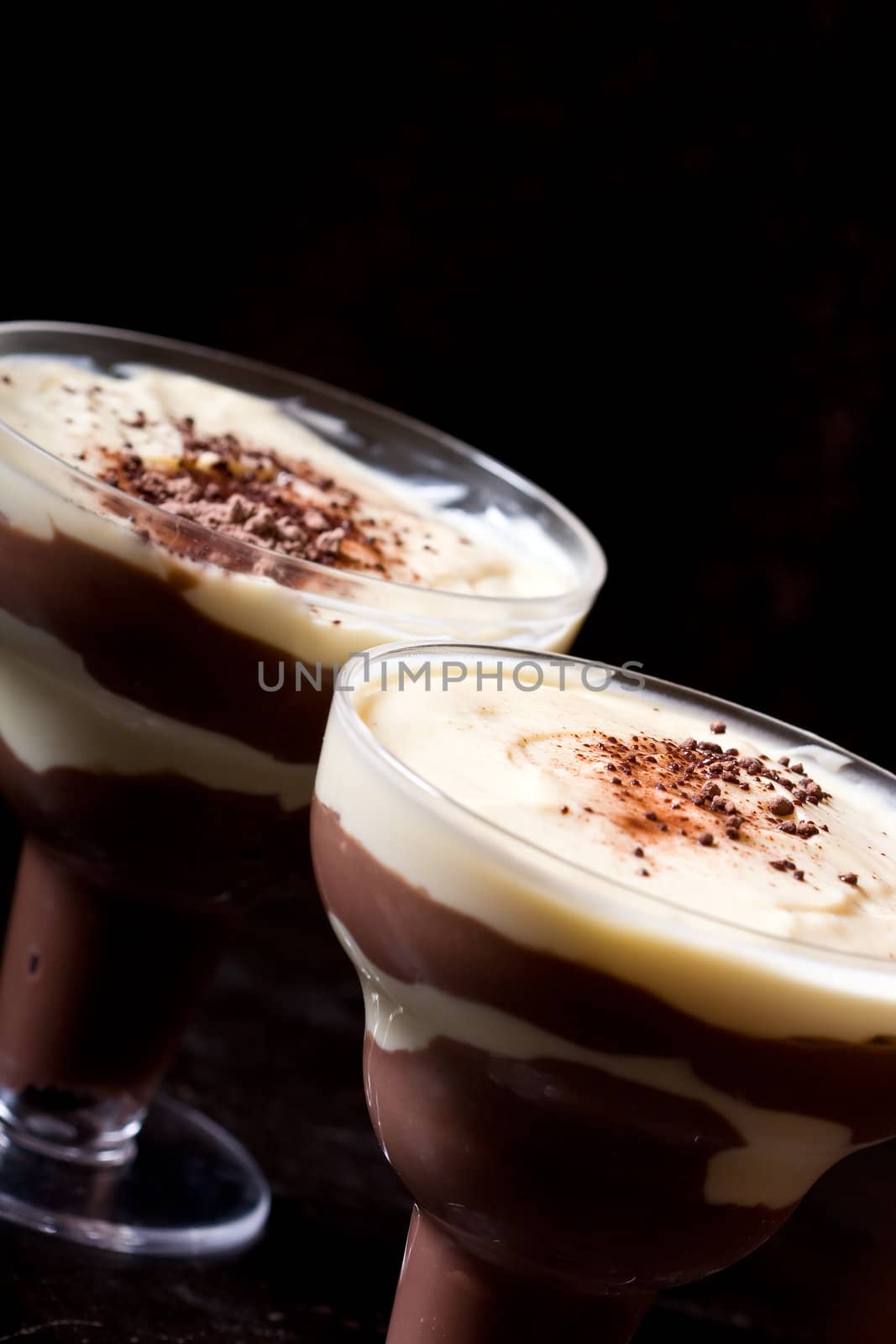 chocolate and vanilla pudding in a parfait glass dusting of chocolate on top